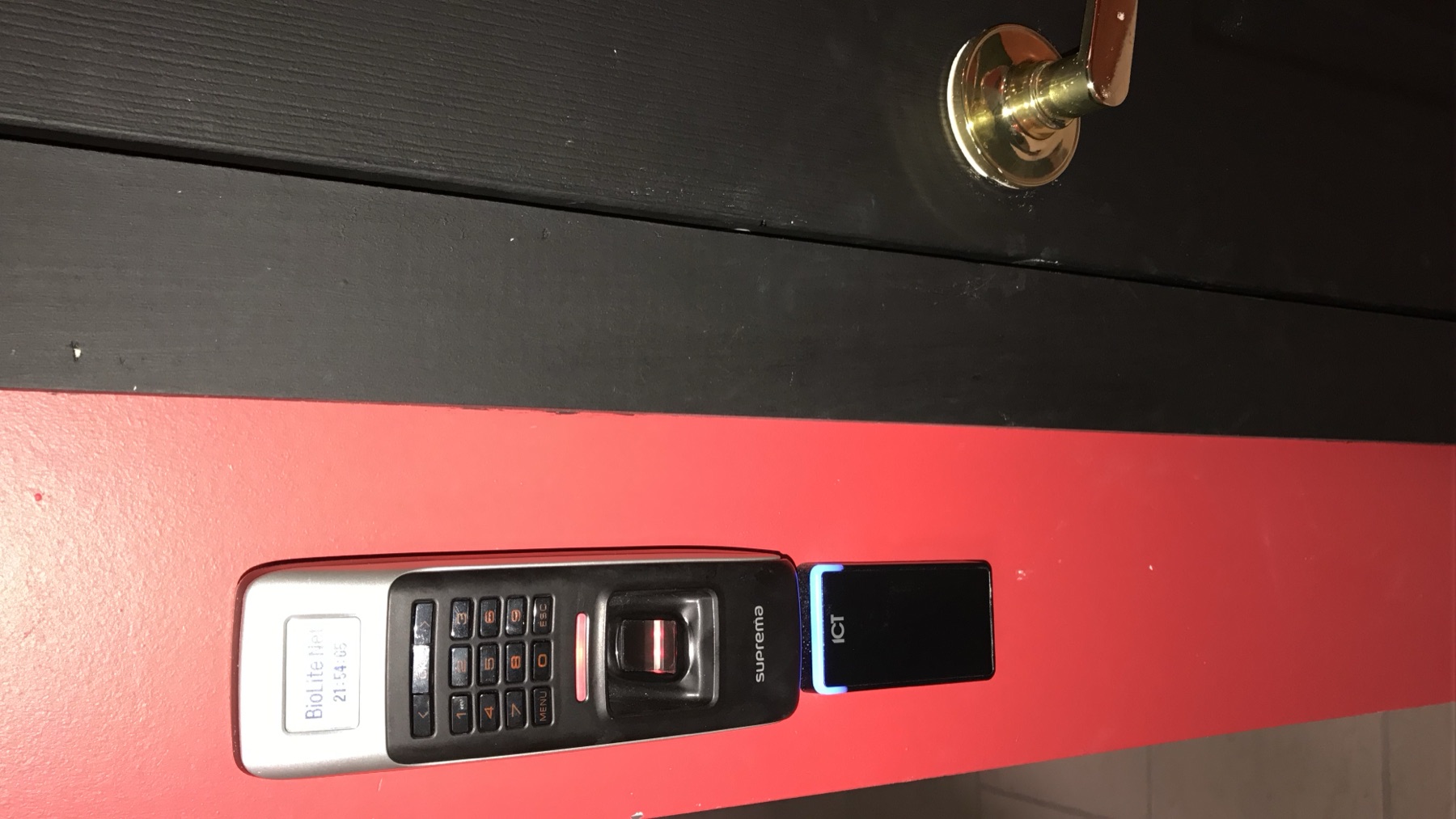 Fingerprint keypad and card reader on a commercial door.