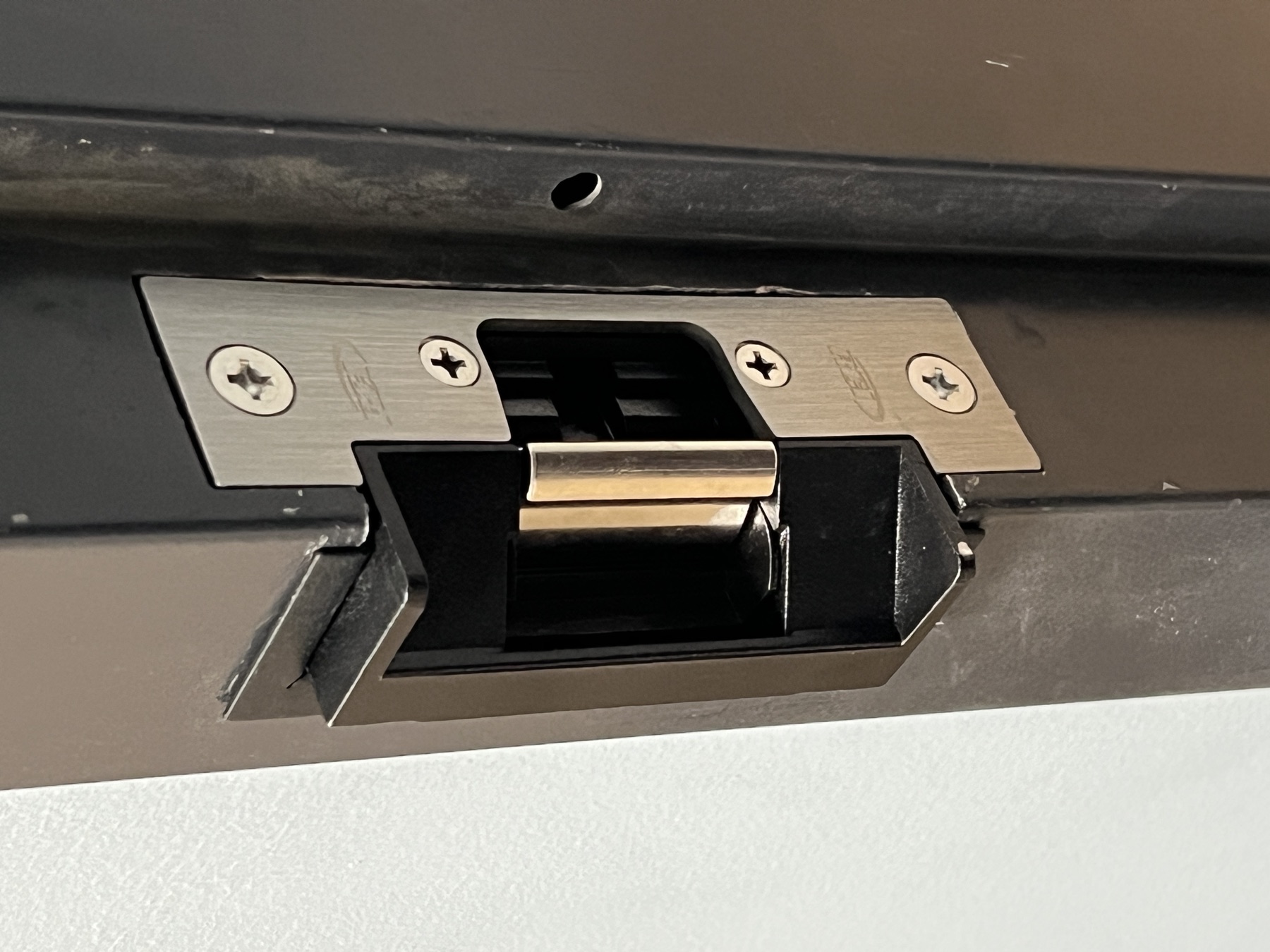 Electric strike flush-mounted in a commercial door frame.