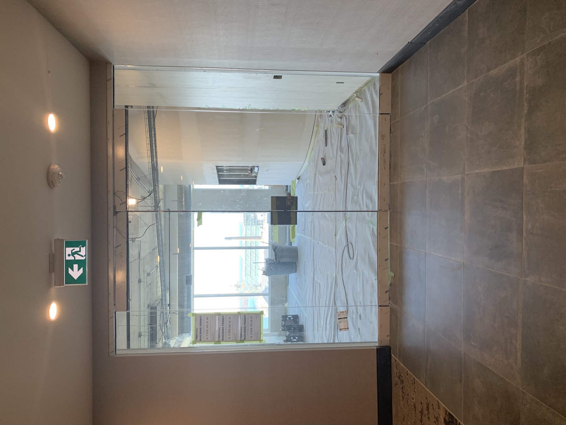 Frameless glass double doors in a commercial interior.