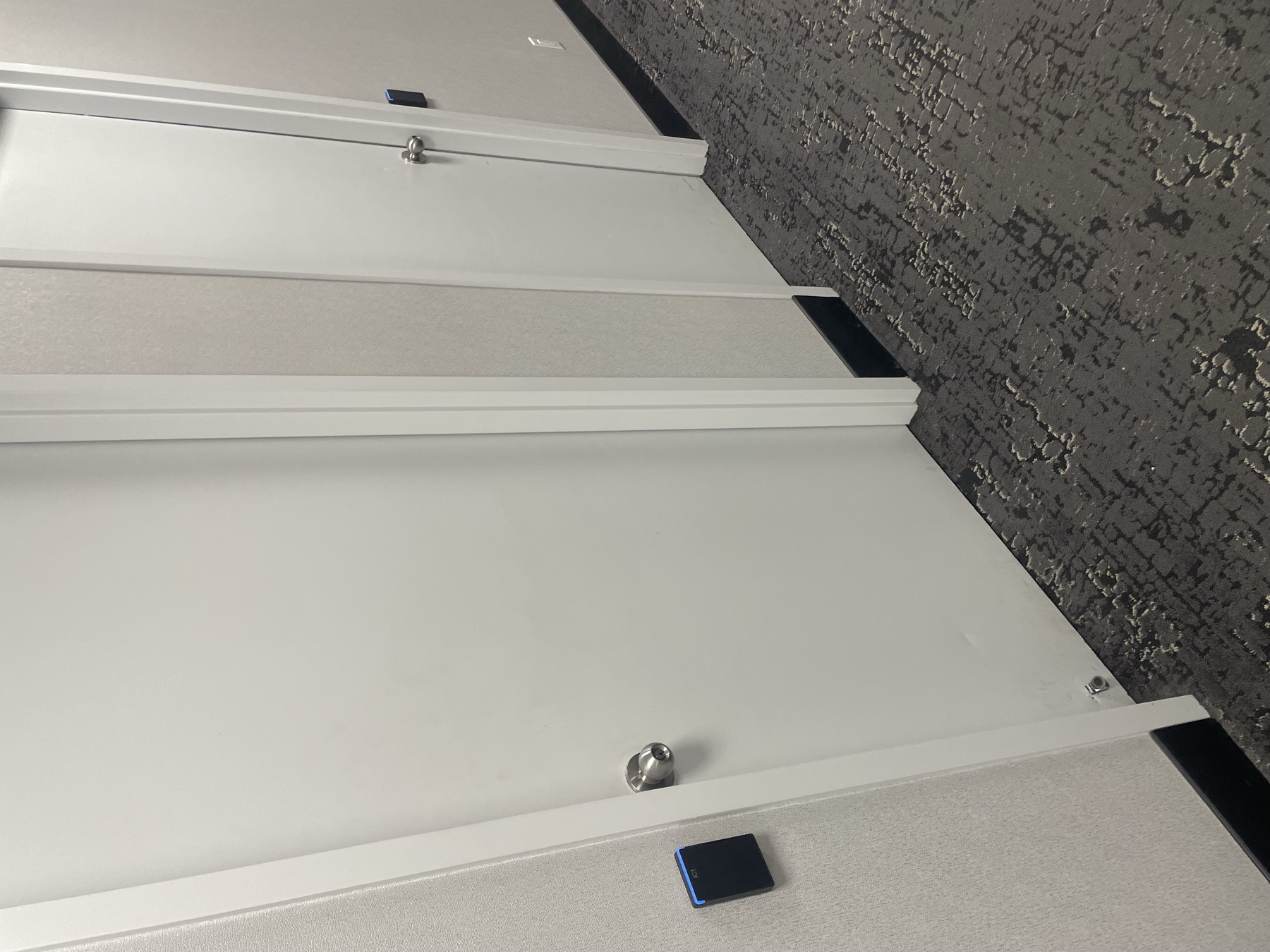ICT readers on consecutive office doors in a corridor.