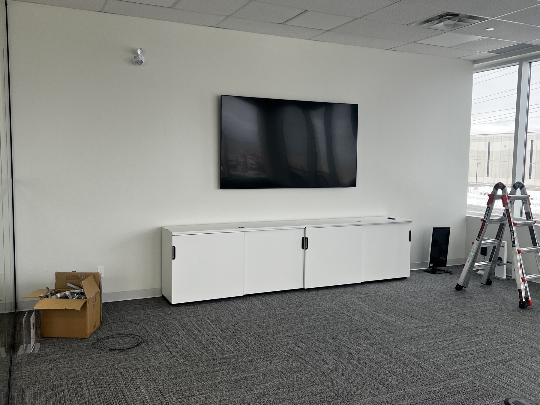 Commercial room during a wall-display and cabling install.