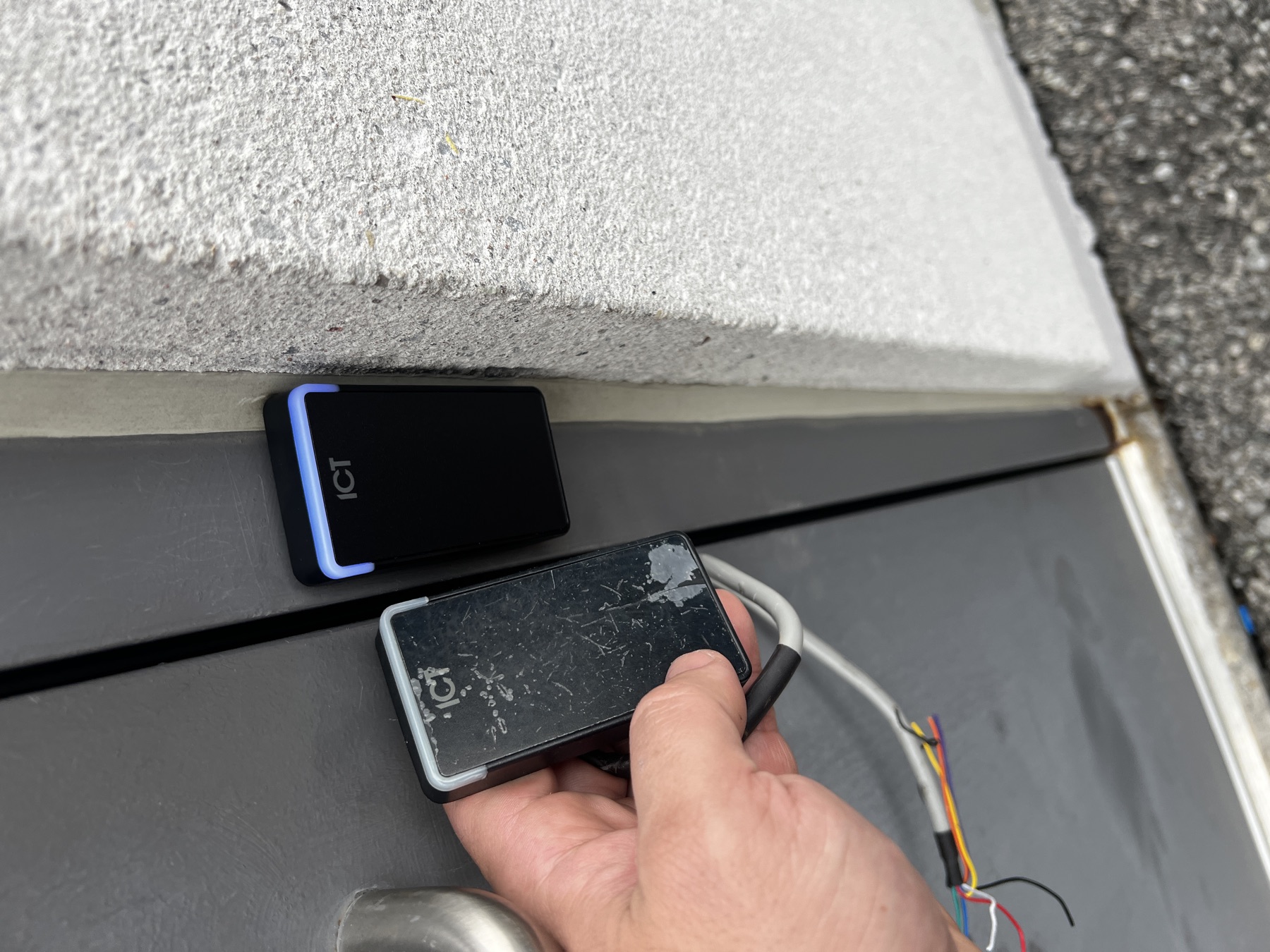 New card reader on a door frame during a replacement.