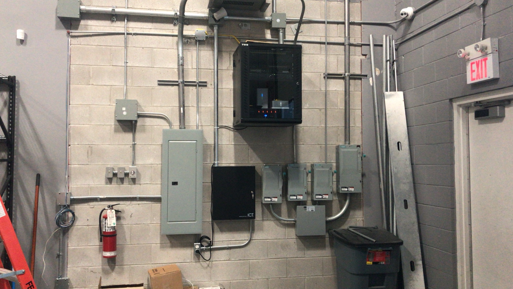 Wall-mount cabinet and electrical panels with neat EMT.